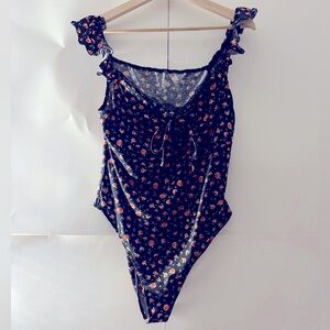 Girlie lace trimmed rose patterned women’s body suit.